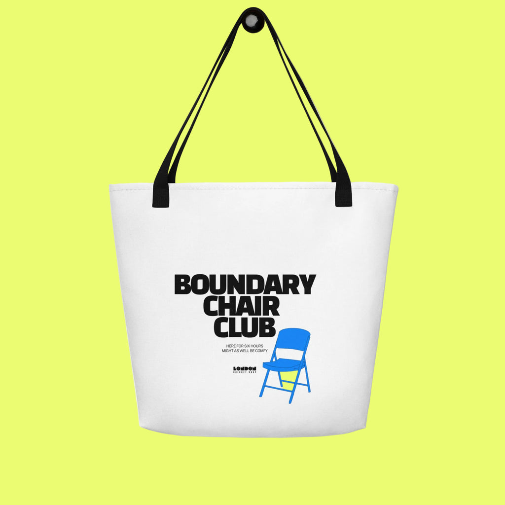 White tote bag with 'Boundary Chair Club' text and blue chair icon on a white background